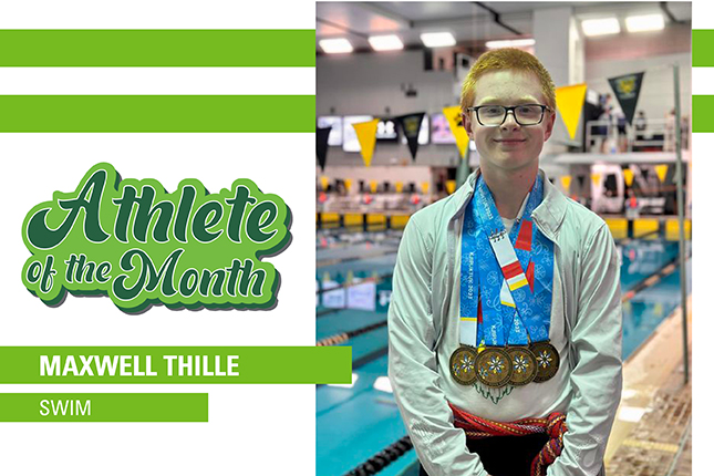 Thirteen year old boy standing in front of indoor swimming pool, with six gold medals hanging on his chest.