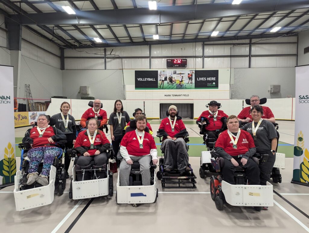Members of the Saskatoon Rolling Thunder power chair soccer team pose for a team photo.